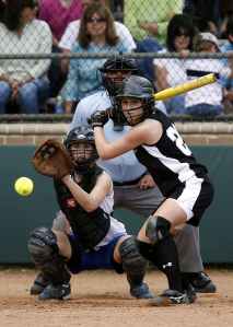 two female in baseball gears in stadium ready to catch and swing baseball